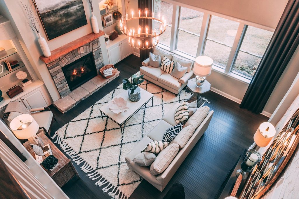 warm living room scene showcasing a fireplace, inviting couches, and a stylish rug beneath them